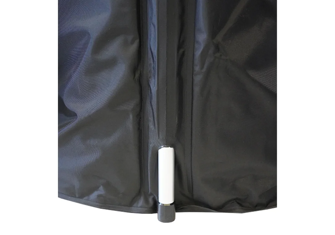Close-up of a black waterproof fabric cover with a white and black plastic toggle valve, likely for a tent or gear bag, shown against a plain white background.