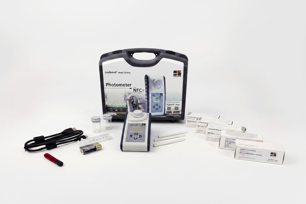 A handheld photometer kit with its carrying case, control unit, cables, reagents, and multiple paper boxes arranged on a white studio background.