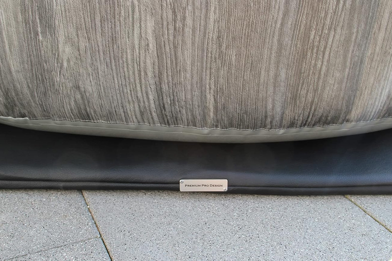Close-up of a textured gray surface with a brand name tag on a tiled floor.