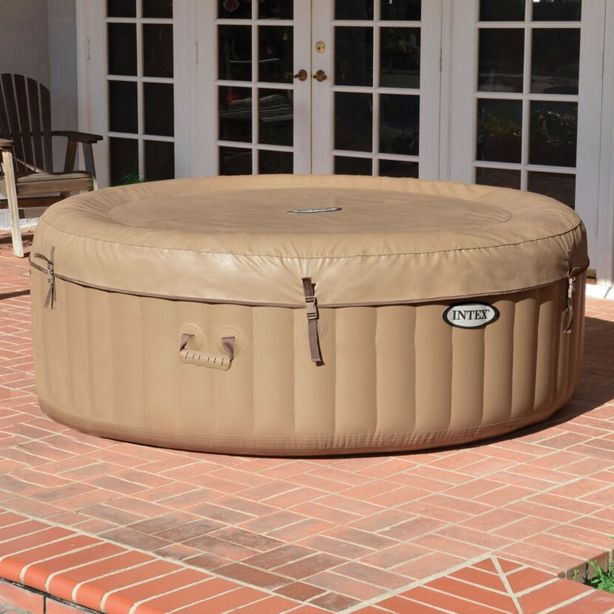 Inflatable hot tub with beige cover on a patio