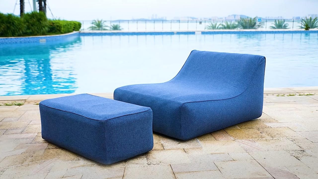 Blue outdoor lounge chair and ottoman by a poolside