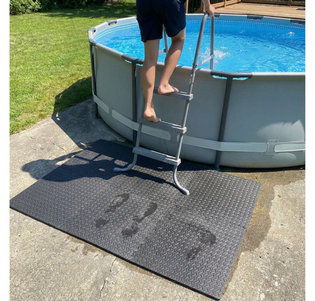 Person using a pool ladder to enter an above-ground pool on a sunny day.