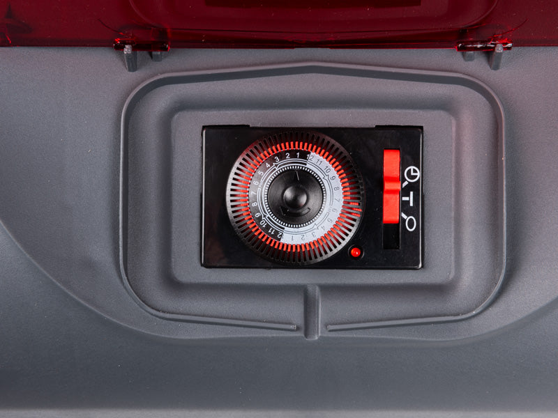 A pool pump timer in red and black.